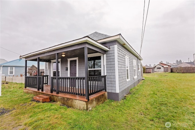 view of front of house with a front lawn and fence