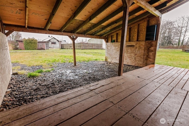 wooden terrace with an outbuilding and fence