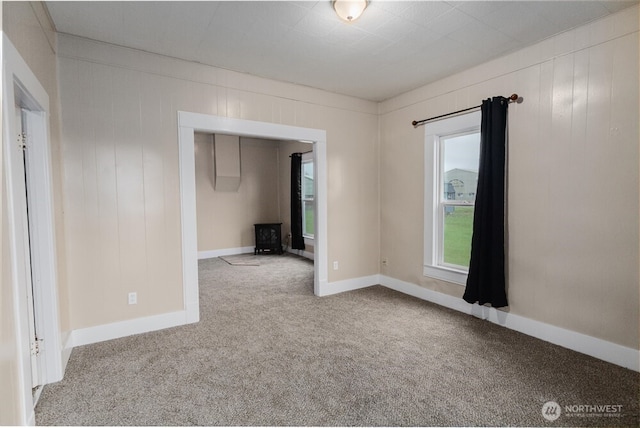 spare room with light carpet and baseboards