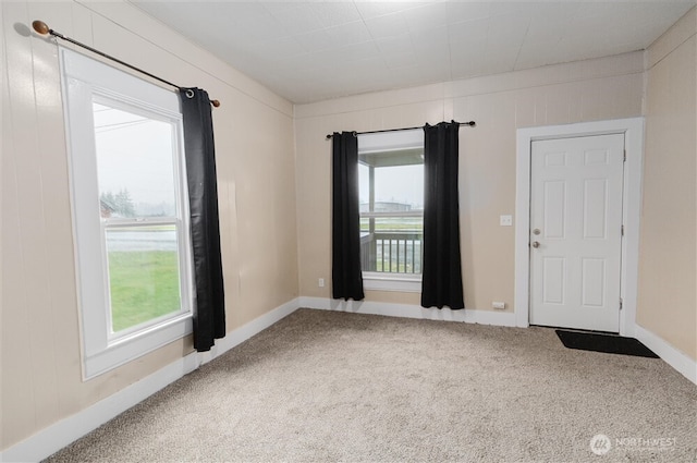 carpeted spare room with baseboards