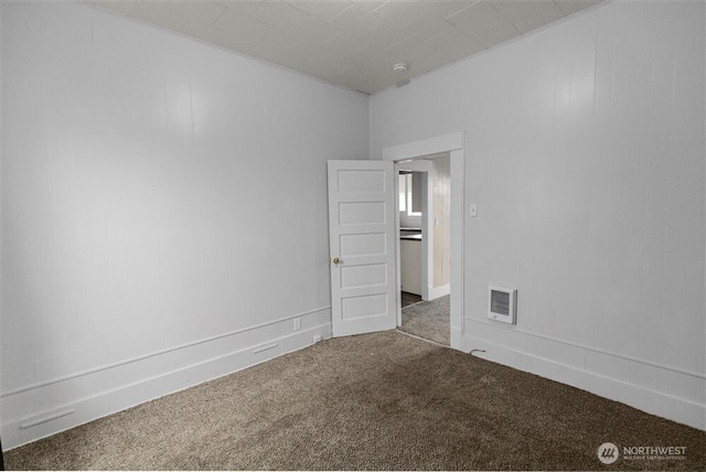 empty room with carpet flooring and visible vents