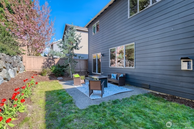 view of yard with a patio area, a fenced backyard, and an outdoor living space