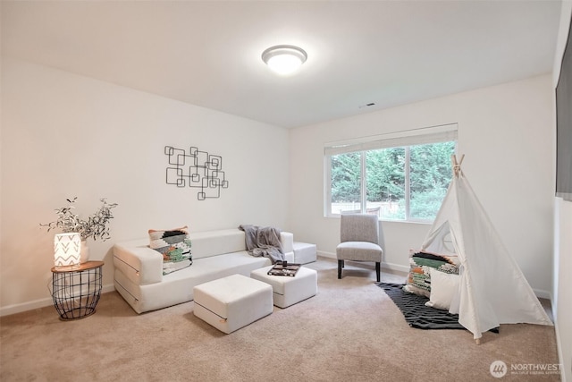 living room featuring carpet flooring, visible vents, and baseboards