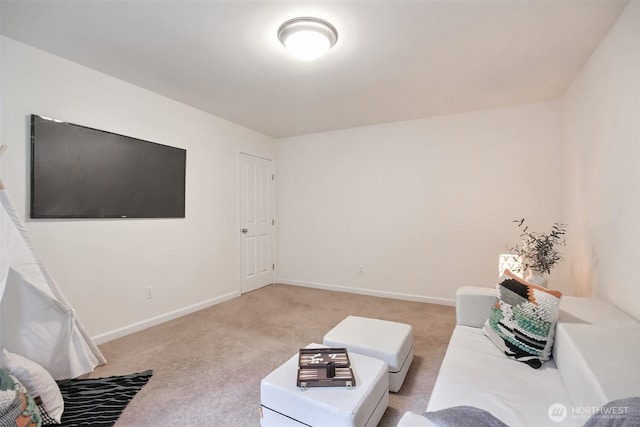 living area featuring baseboards and light colored carpet