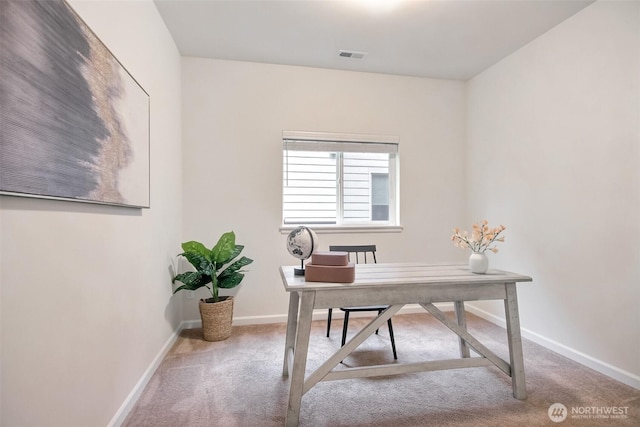 carpeted office space with visible vents and baseboards