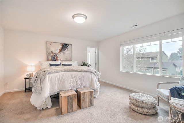 carpeted bedroom featuring visible vents and baseboards