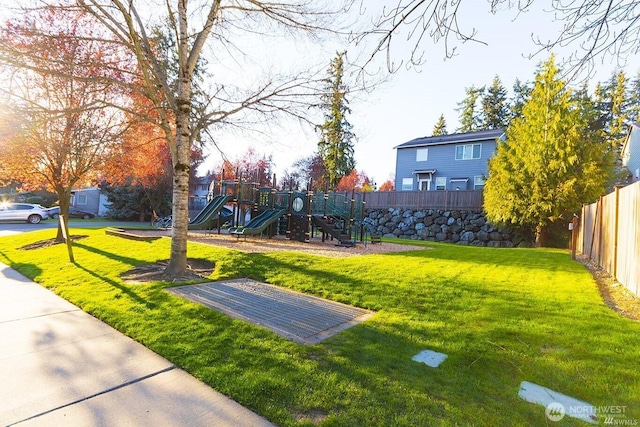 view of yard with fence and a playground