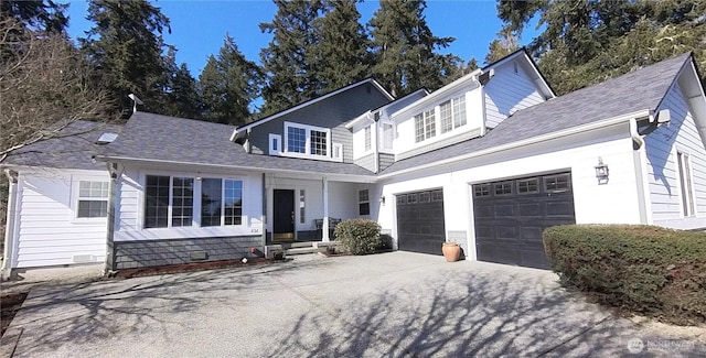 traditional-style home featuring a garage, driveway, a shingled roof, and crawl space