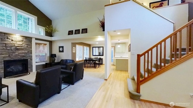 living area featuring plenty of natural light, stairway, and wood finished floors