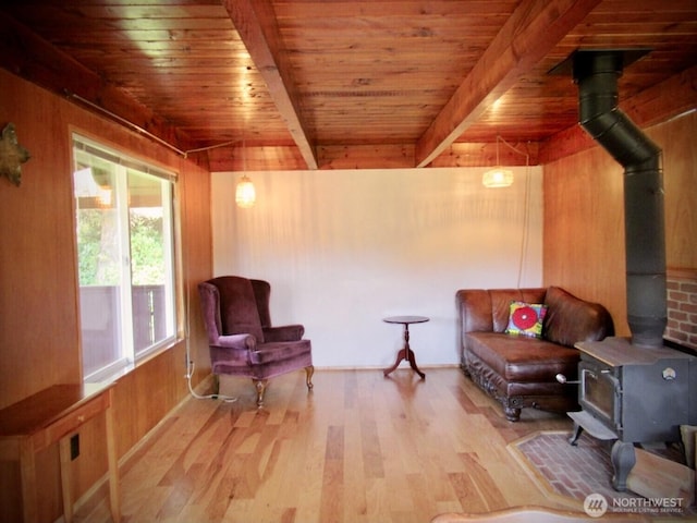 845 Schmid Rd, Grayland, WA 98547 - sitting room featuring a wood stove, wood ceiling, wood finished floors, wooden walls, and beamed ceiling