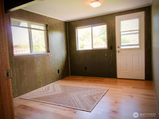 845 Schmid Rd, Grayland, WA 98547 - doorway to outside with healthy amount of natural light, wood finished floors, and wood walls