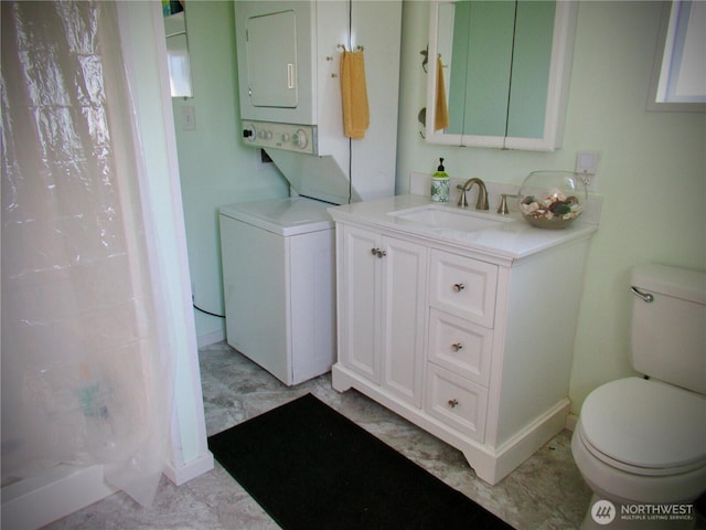 845 Schmid Rd, Grayland, WA 98547 - bathroom featuring estacked washer and dryer, toilet, vanity, curtained shower, and marble finish flooring