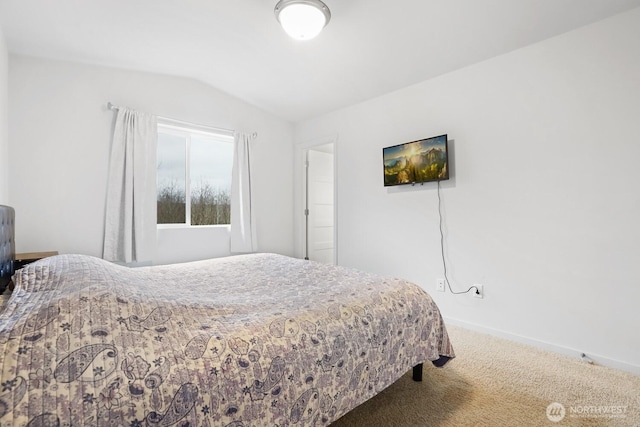 carpeted bedroom with lofted ceiling and baseboards