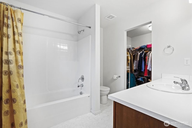 full bath with toilet, visible vents, vanity, a spacious closet, and shower / bath combo