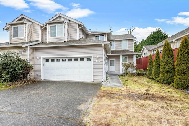 view of front of house with aphalt driveway and a garage