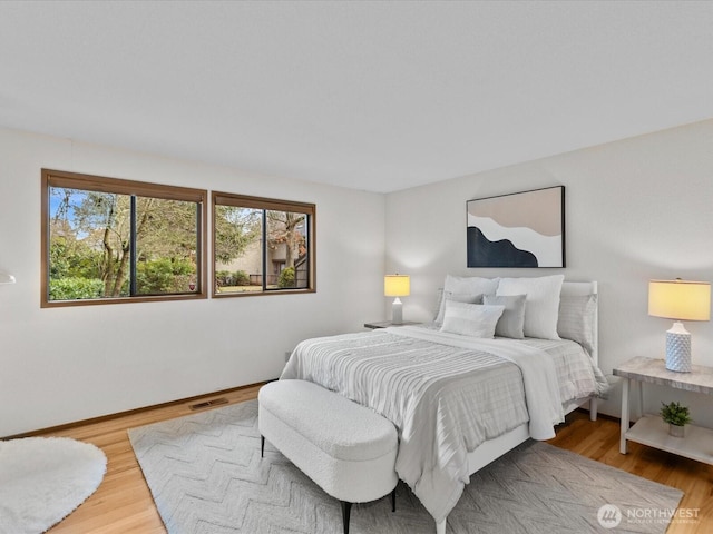 bedroom with visible vents and light wood-style flooring