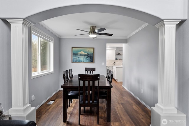 dining room featuring decorative columns, visible vents, arched walkways, ornamental molding, and dark wood-style flooring