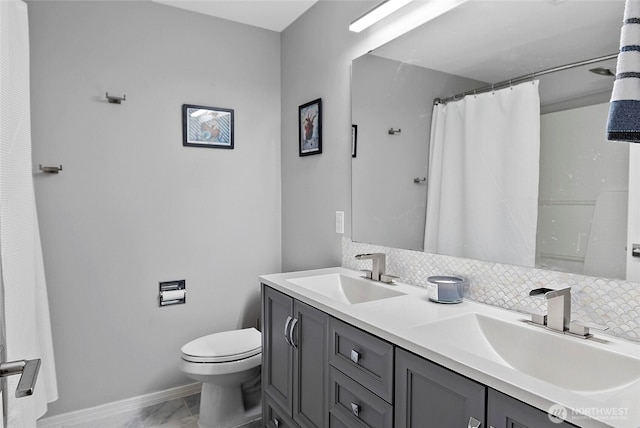 full bathroom featuring double vanity, a sink, and decorative backsplash