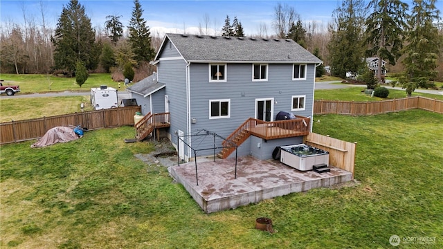 rear view of house featuring a fenced backyard, stairway, a lawn, a wooden deck, and a patio area