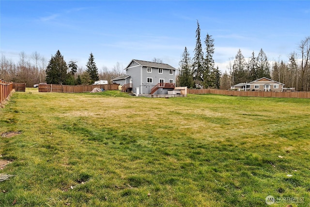 view of yard with a deck and fence