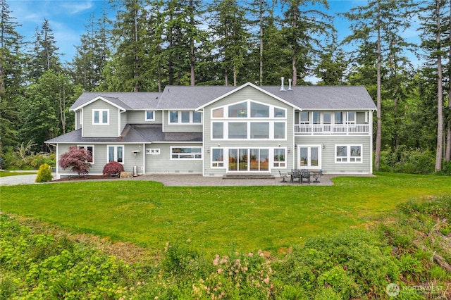 rear view of property featuring a yard and a patio