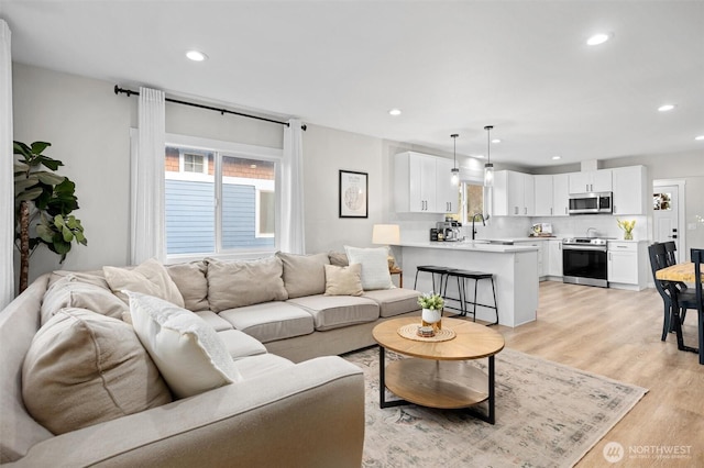 living room featuring light wood-style floors and recessed lighting