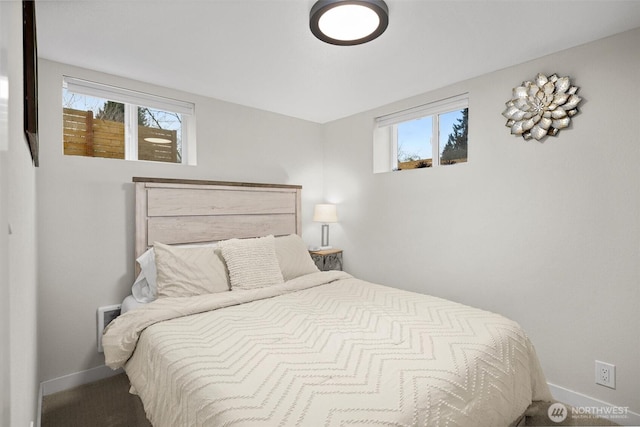 bedroom with multiple windows and baseboards