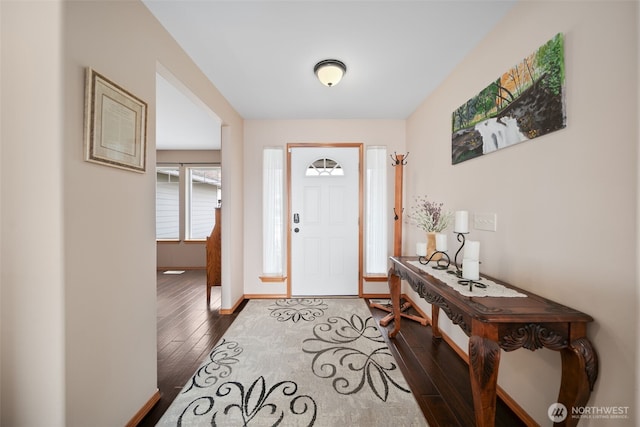 entrance foyer with baseboards and dark wood-type flooring