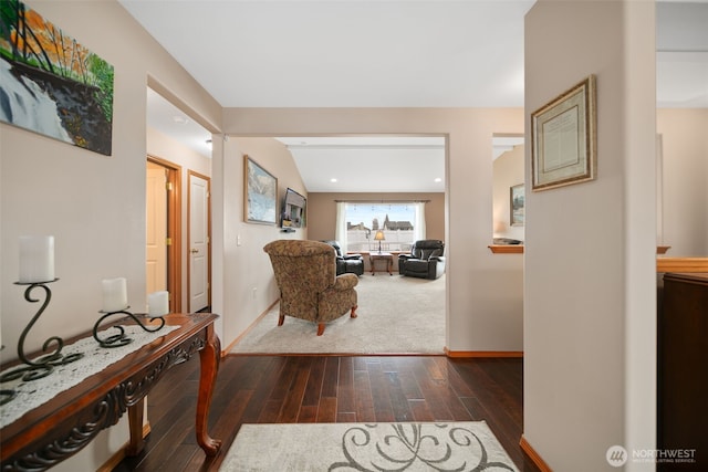 hall with dark wood-style floors and baseboards