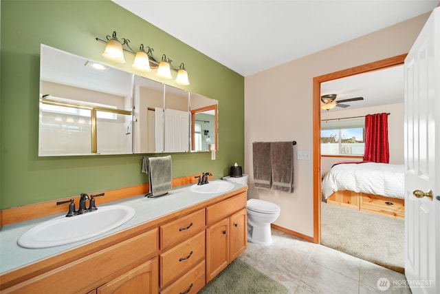 bathroom featuring tile patterned flooring, connected bathroom, a sink, and double vanity