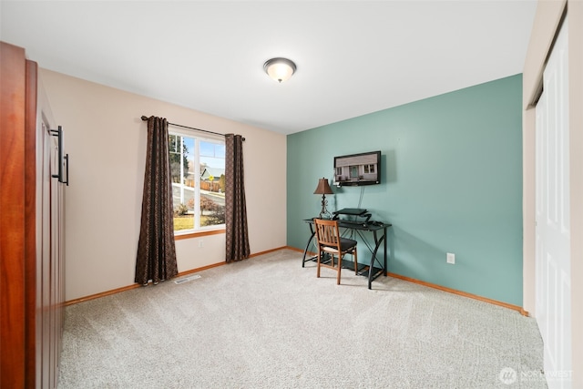 carpeted home office featuring baseboards and visible vents