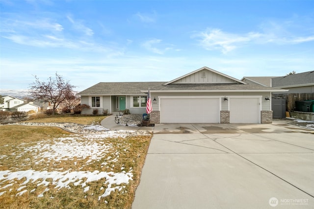 single story home featuring an attached garage, driveway, board and batten siding, and brick siding