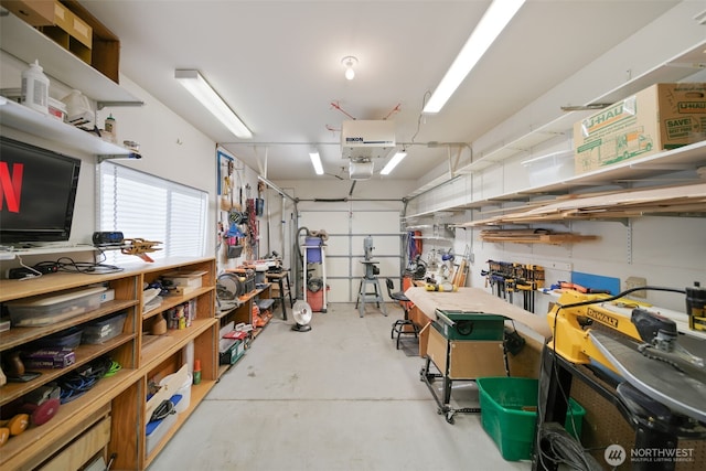 garage featuring a garage door opener and a workshop area