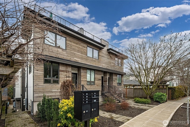 view of front of property featuring a chimney and fence