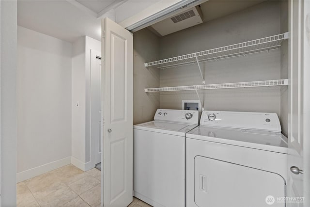 laundry room featuring laundry area, light tile patterned floors, baseboards, visible vents, and washer and clothes dryer