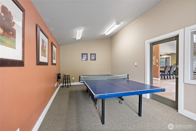 recreation room with lofted ceiling, baseboards, and carpet