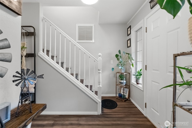 foyer featuring stairway, wood finished floors, visible vents, and baseboards