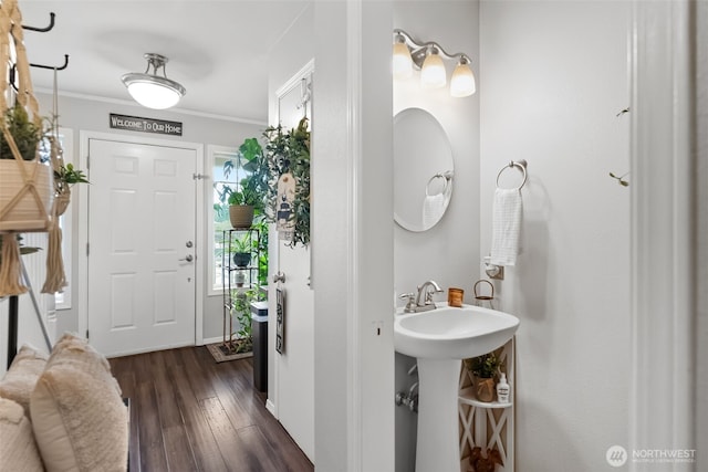 bathroom featuring wood finished floors and crown molding