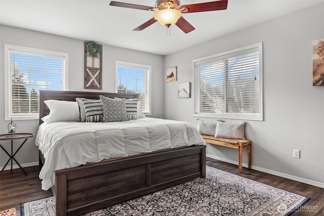 bedroom with wood finished floors, a ceiling fan, and baseboards