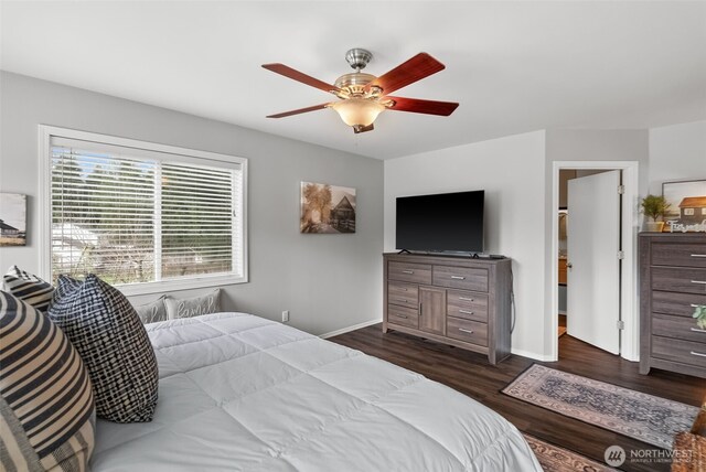 bedroom featuring ceiling fan, dark wood-style flooring, and baseboards