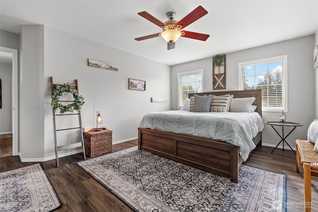 bedroom with wood finished floors, a ceiling fan, and baseboards