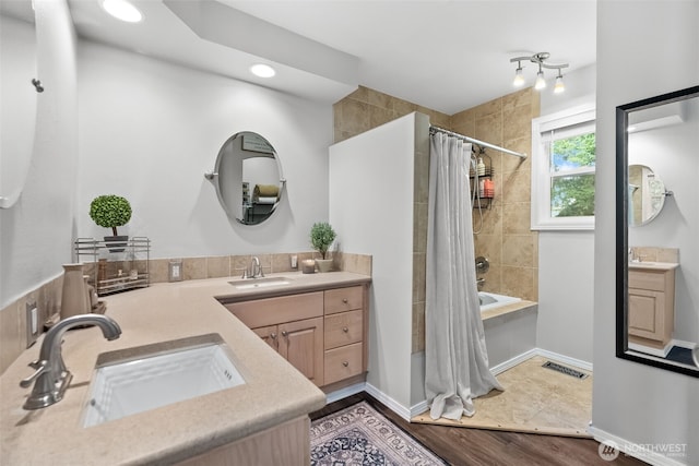 full bathroom featuring visible vents, shower / tub combo with curtain, vanity, and baseboards