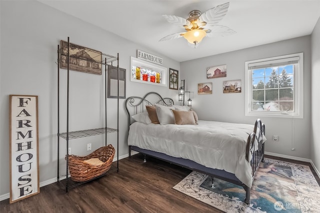 bedroom with ceiling fan, dark wood-style flooring, and baseboards