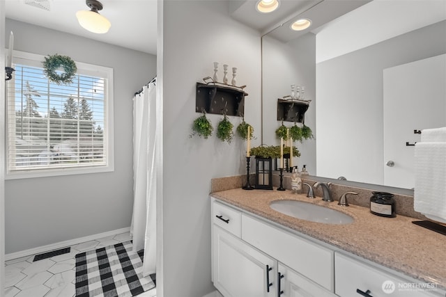 bathroom featuring baseboards, visible vents, a shower with shower curtain, tile patterned floors, and vanity