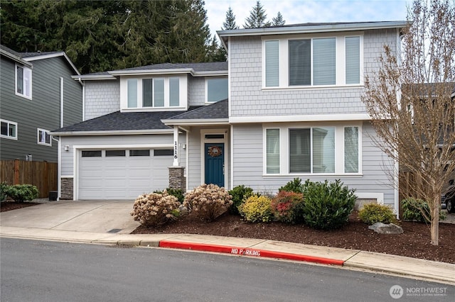 view of front of property featuring driveway, fence, and roof with shingles