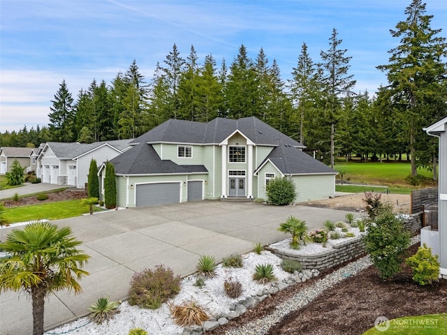 view of front of property with a garage and concrete driveway