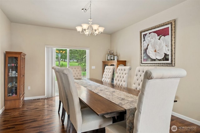 dining area with dark wood-type flooring, baseboards, and an inviting chandelier