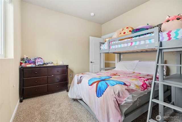 bedroom with carpet floors and baseboards