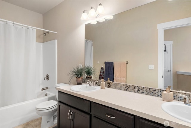 full bath featuring tile patterned flooring, toilet, vanity, tasteful backsplash, and shower / bath combo with shower curtain