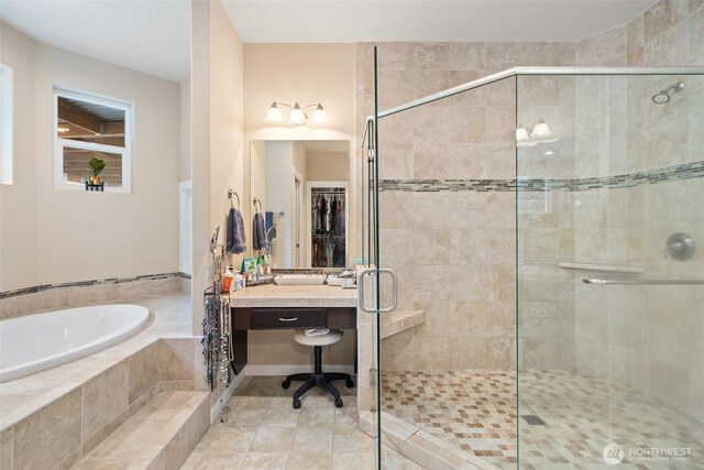 bathroom featuring a garden tub, a shower stall, and tile patterned floors